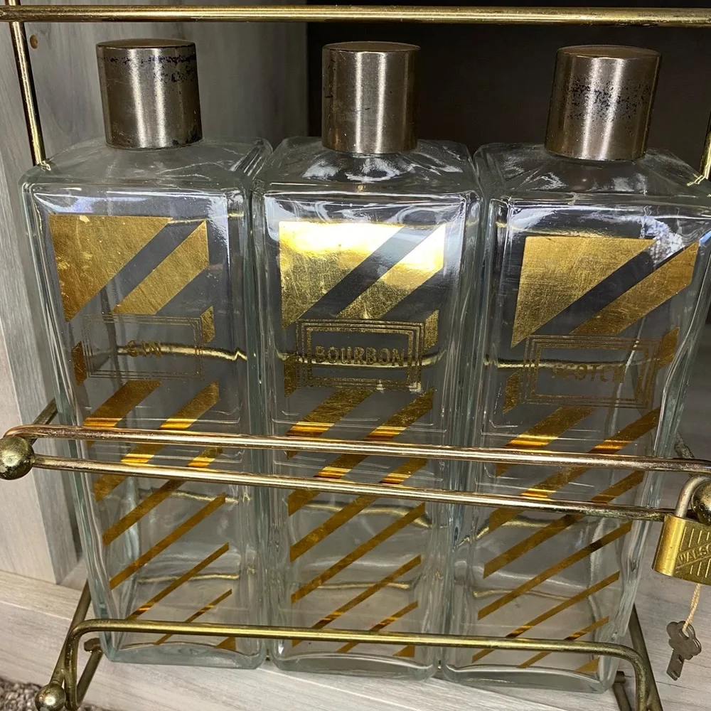 Vintage Decanter with Caddy, three bottle tantalus w Scotch, Bourbon Gin Labels